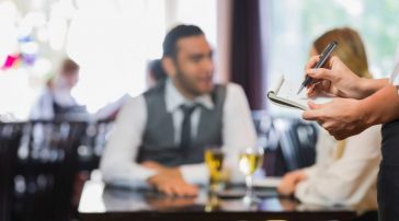 Server taking order for a table of people