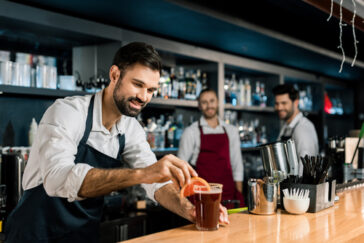 bartenders and servers behind the bar