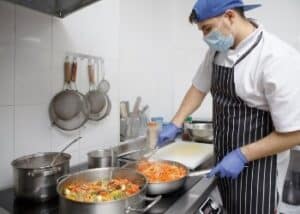 a cook in the kitchen preparing food