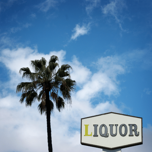 palm tree in Florida next to liquor sign