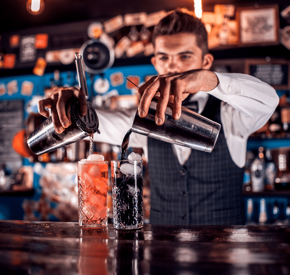 bartender mixing drinks with two shakers